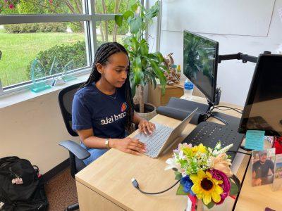 联邦勤工俭学学生MIeraf Teshome确实在为她的雇主Card Isle使用笔记本电脑工作.