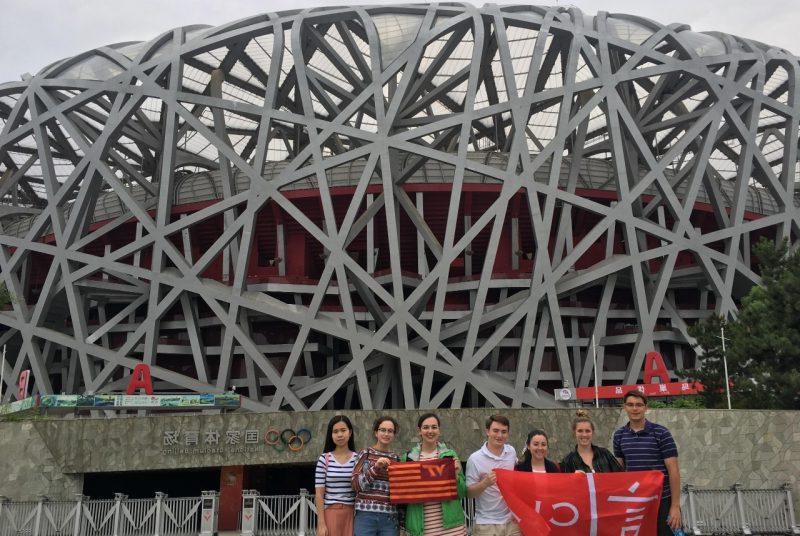 买球app students st和 in front of 的 Olympic Stadium in Beijing, China